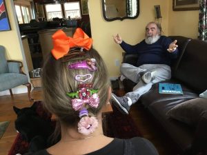 A photograph of a woman wearing a lot of barettes.