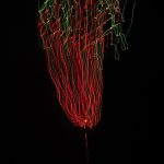 A photograph of a red-and-green firework.