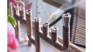 A photograph of smoke coming out of a menorah.