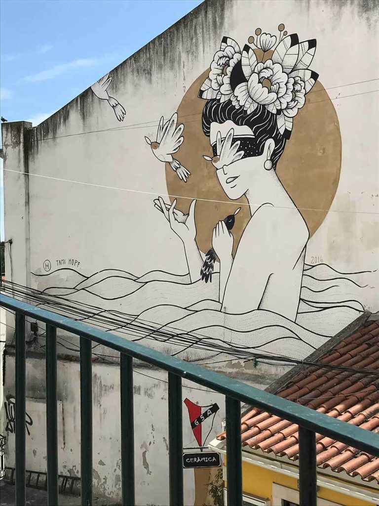 A photograph of a mural in a city street.