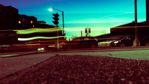 A photograph of a city street at night with blurry lines of light.
