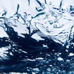 A photograph of water filled with bubbles.