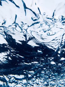 A photograph of water filled with bubbles.