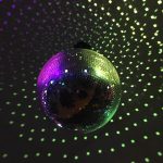 A photograph of a disco ball reflecting pinpricks of multicoloured light.