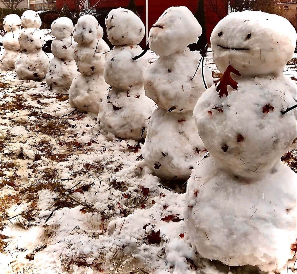 A photograph of a row of dirty snowmen.