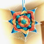 Photograph of a multicolored knitted design resembling an 8-point star