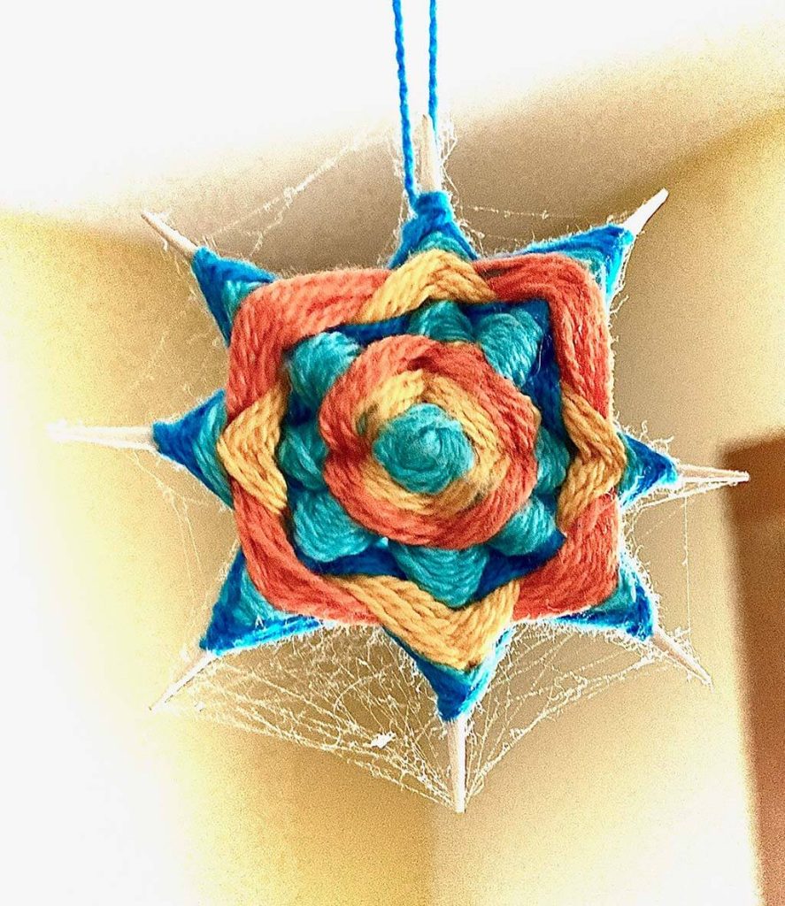 Photograph of a multicolored knitted design resembling an 8-point star